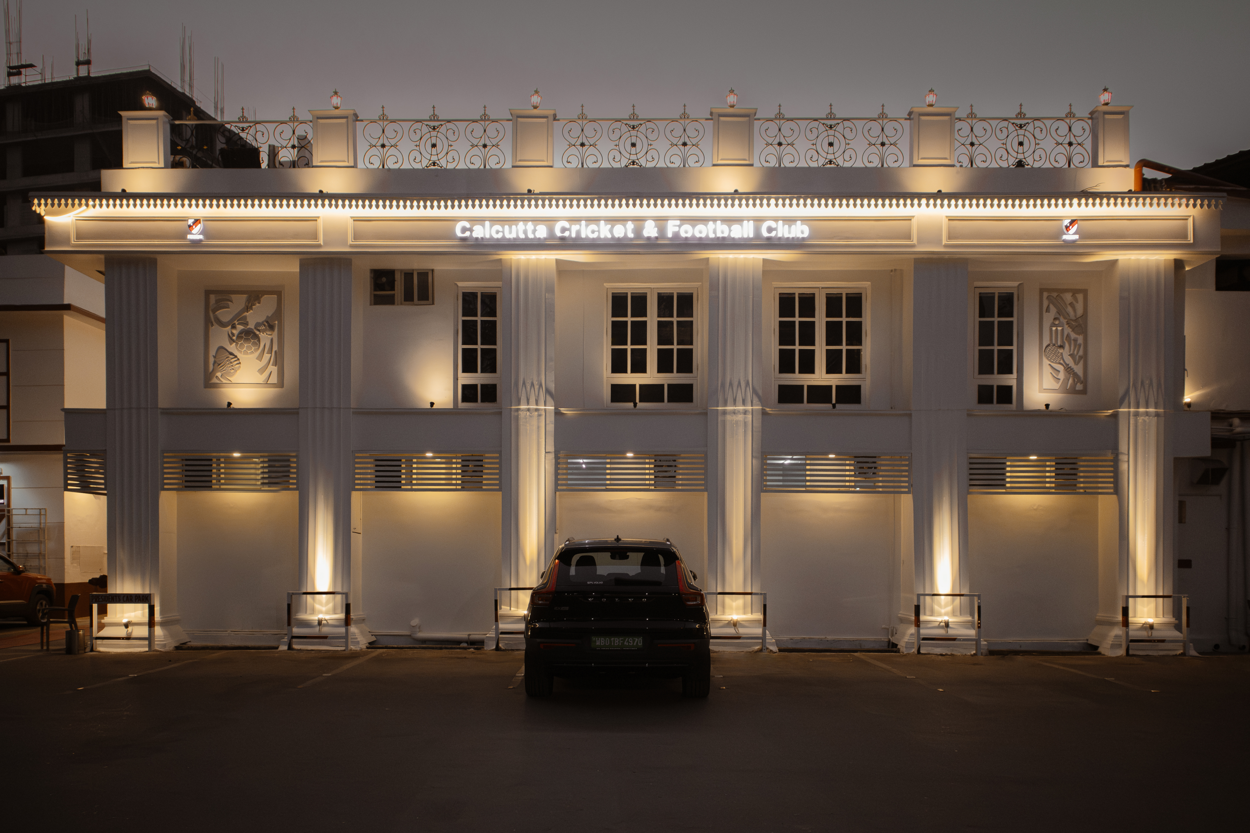 Restored neoclassical exterior of Calcutta Cricket and Football Club illuminated at night, heritage restoration Kolkata
