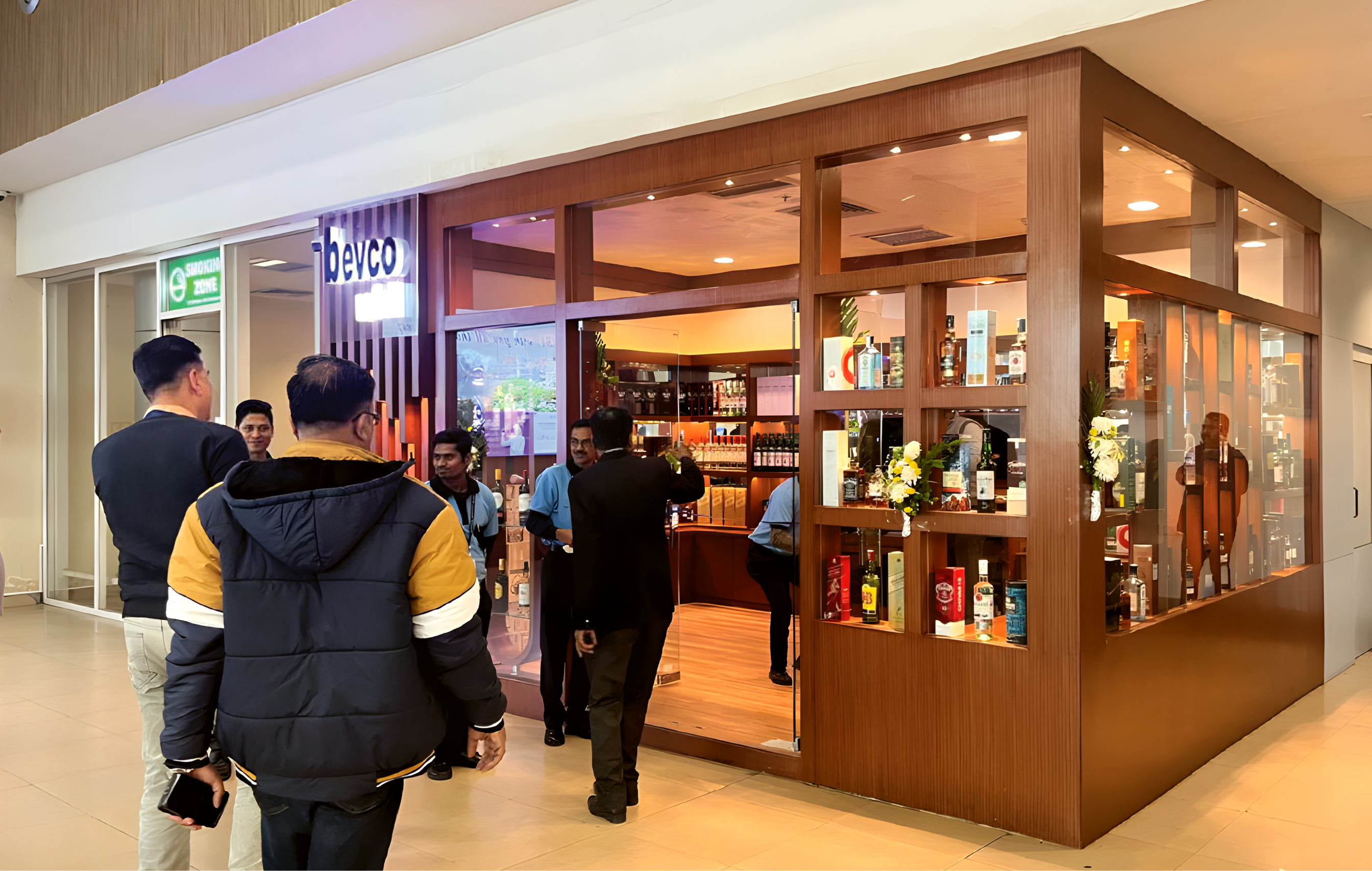 BEVCO liquor retail outlet at Kazi Nazrul Islam Airport Durgapur with premium wood and glass storefront design